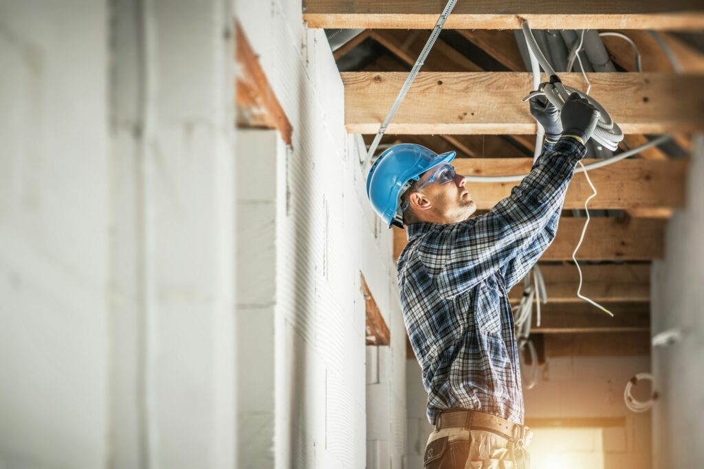 Electrician Installing Wiring System in the Ceiling