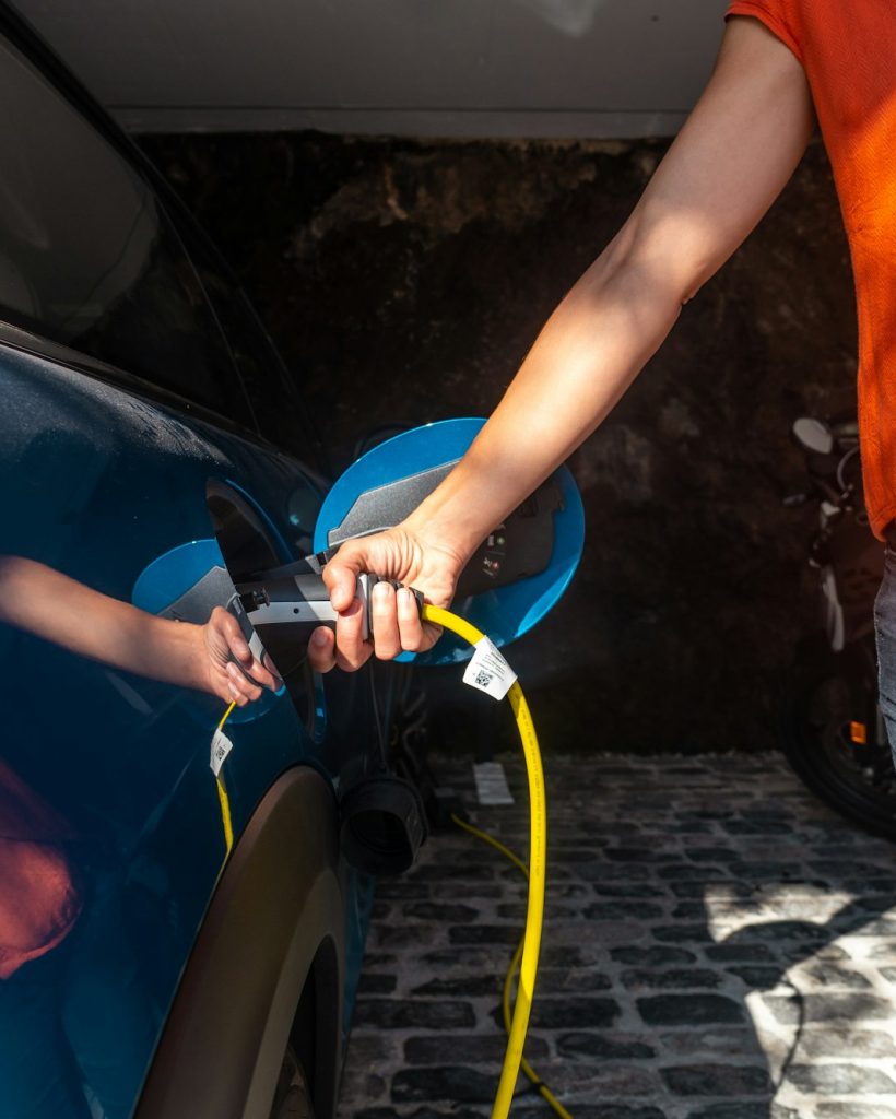 Charging an electric car charging the batteries in the garage at home, not gasoline