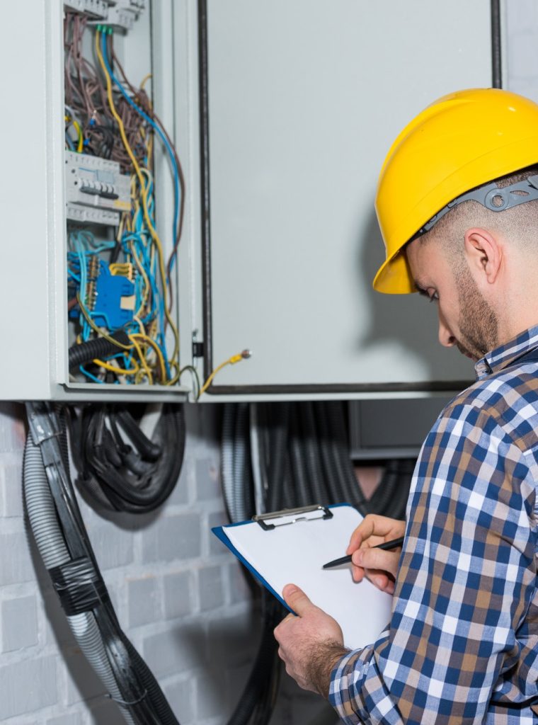 professional-electrician-inspecting-wires-in-electrical-box.jpg